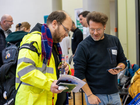 Ein Mitarbeiter der Lebenshilfe Pflege und Assistenz gGmbH informiert einen Besucher.